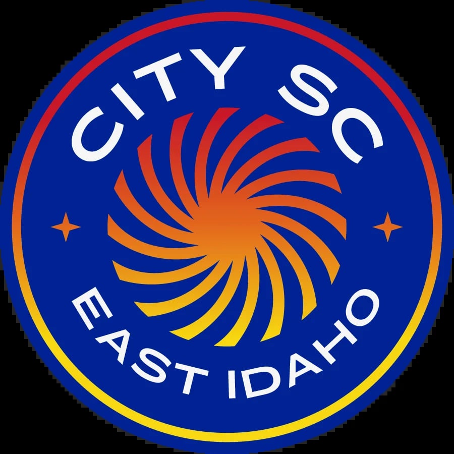 City of Coeur dAlene East Idaho logo featuring a spiral sun design in orange and yellow on a blue circular background