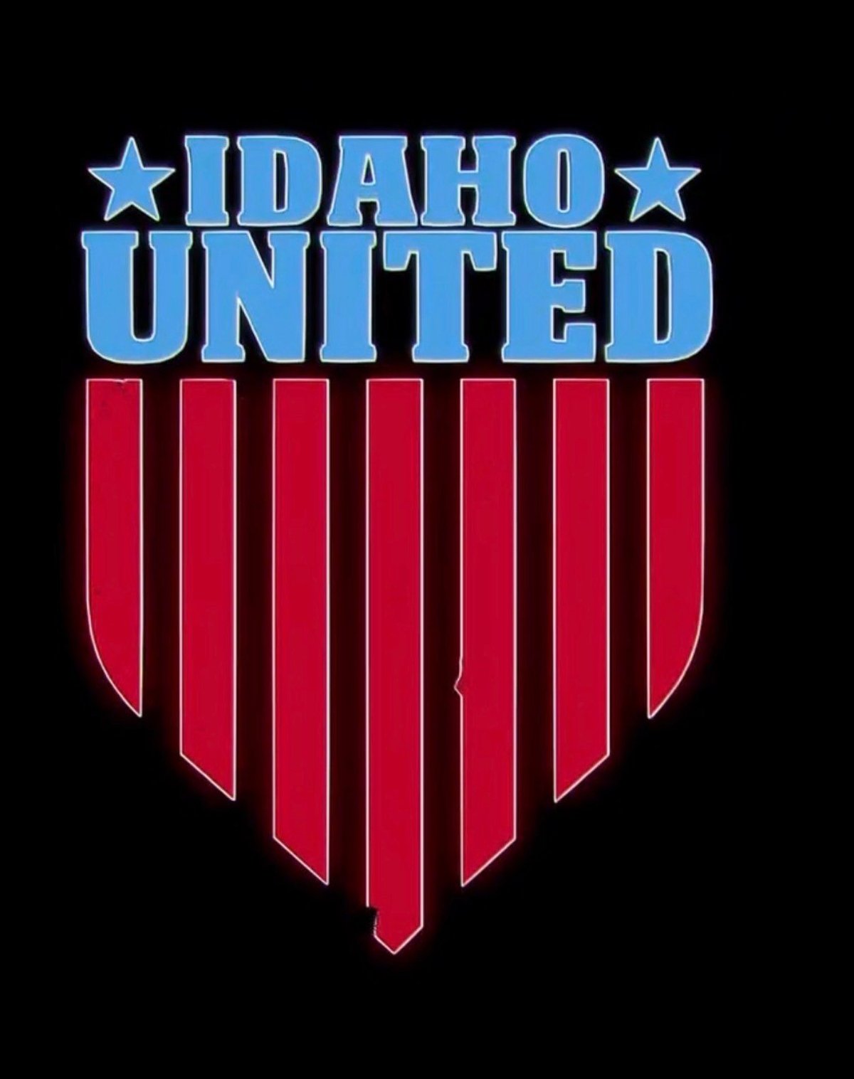 Idaho United logo with blue text and stars above red vertical stripes forming a shield on black background