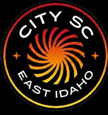City SC East Idaho soccer club logo with orange spiral design on black background with red and yellow circular border